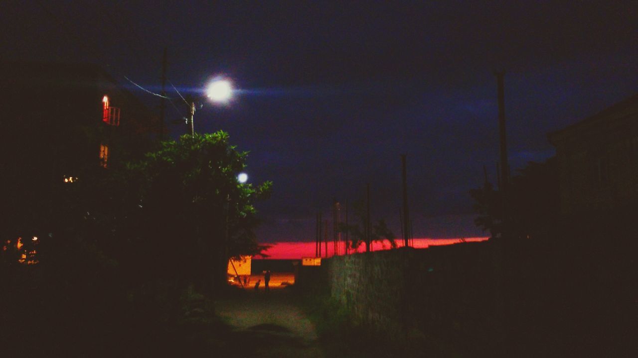 night, illuminated, sky, transportation, street light, tree, building exterior, built structure, architecture, road, dusk, street, lighting equipment, outdoors, long exposure, motion, mode of transport, light - natural phenomenon, no people, copy space