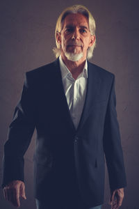 Portrait of mature man standing at home