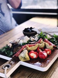 Close-up of person preparing food on table