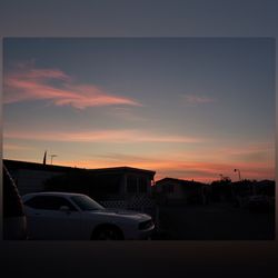 Silhouette buildings against sky at sunset