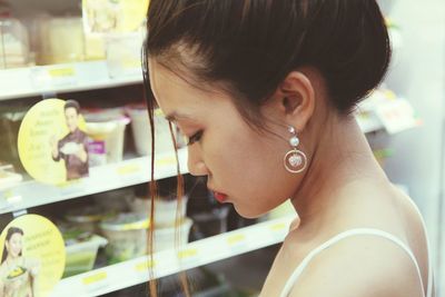 Portrait of young woman looking at store