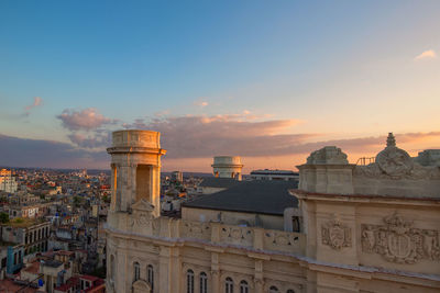Buildings in city during sunset
