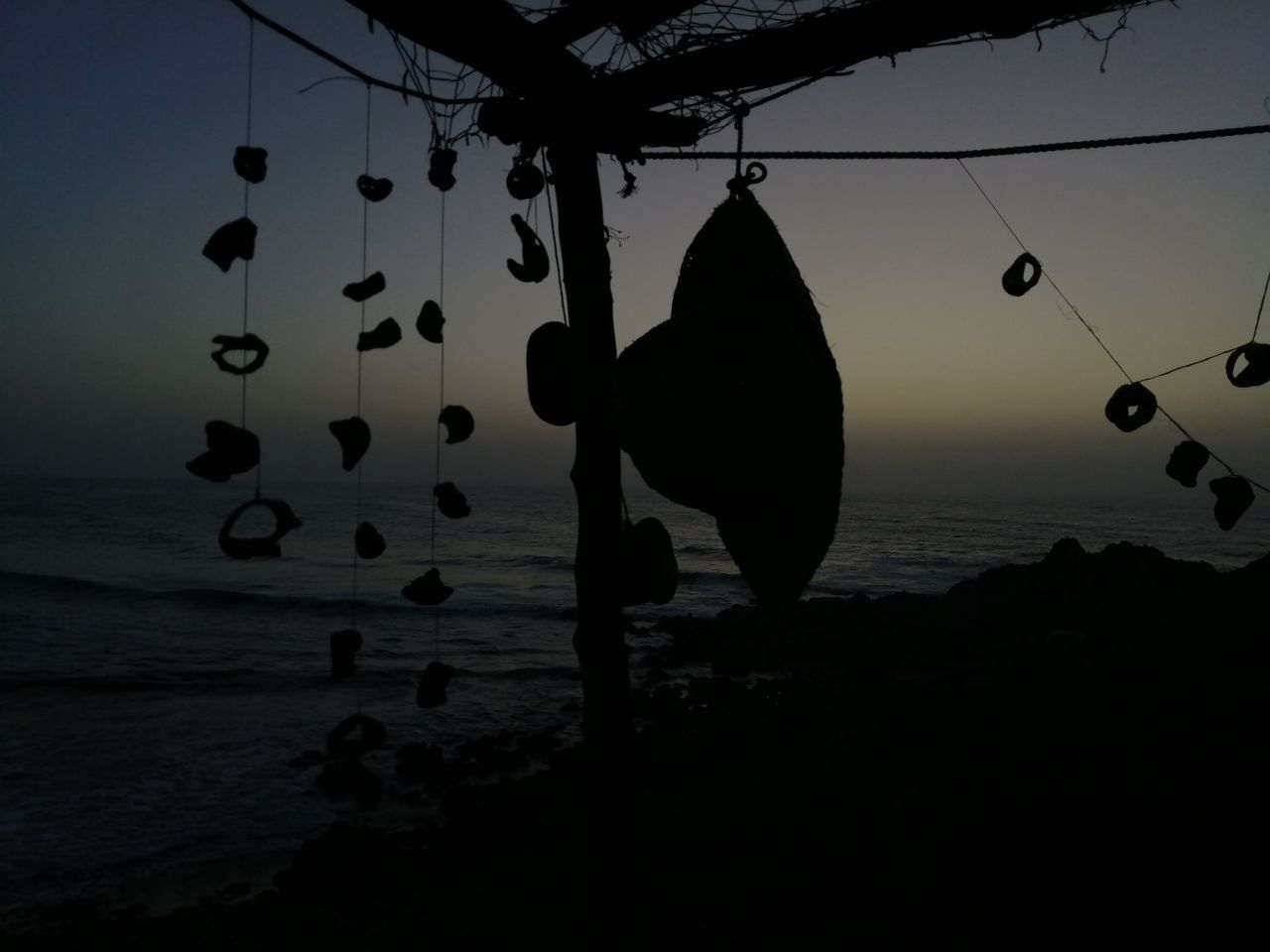 SILHOUETTE OF TWO PEOPLE HANGING ON BEACH