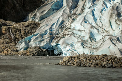 Scenic view of frozen lake against rocks