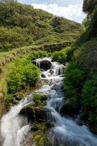 Long exposure of a waterfall flowing onto lee abbey beach in devon