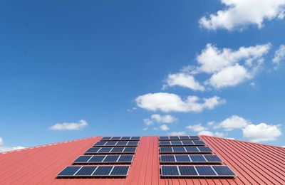 Low angle view of solar panel against blue sky