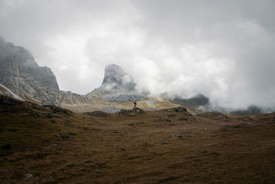 Low angle view of man on rock against sky