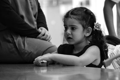 Close-up of siblings playing on table at home