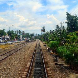 Railroad track against cloudy sky