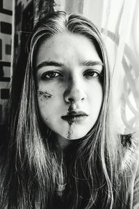 Close-up portrait of young woman with wound