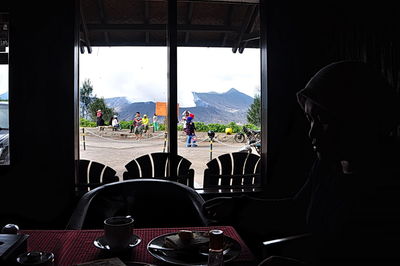 People sitting at restaurant table against window