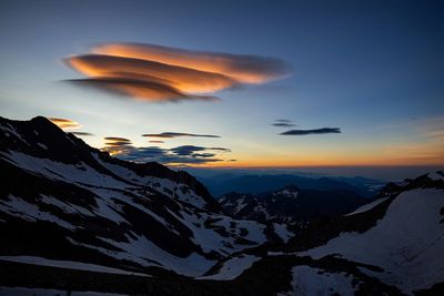 Scenic view of snowcapped mountains against sky during sunset