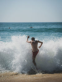Full length of man surfing on sea
