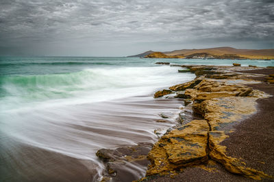 Ancient volcanic rocks on the beaches of the paracas national reserve