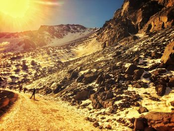 Scenic view of mountains against sky on sunny day