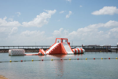 Sailboat on bridge over river against sky