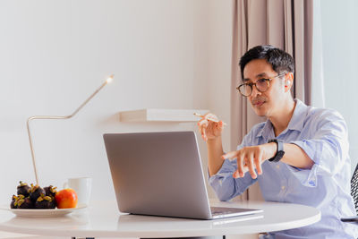 Portrait of businessman having video call on laptop computer