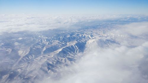 Aerial view of snowcapped mountain against sky