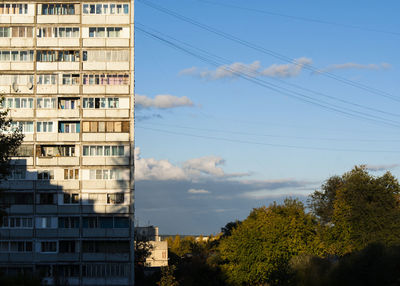 Buildings against cloudy sky