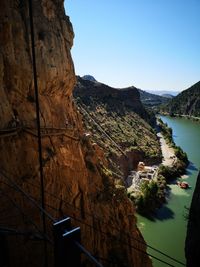 Scenic view of river and mountains against clear sky