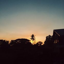 Low angle view of silhouette trees against sky at sunset