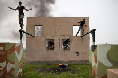 Low angle view of man standing against built structure