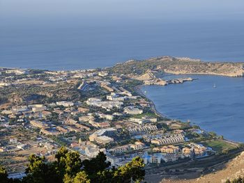 High angle view of townscape by sea against sky