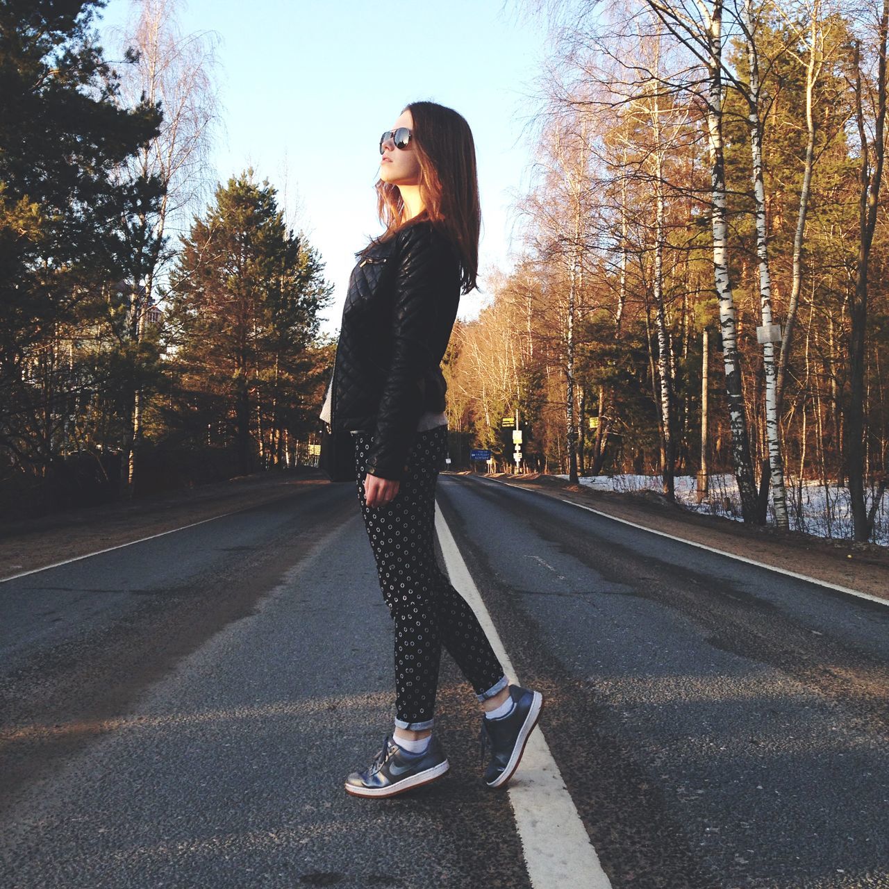 transportation, tree, lifestyles, road, full length, leisure activity, the way forward, young adult, front view, casual clothing, street, road marking, skateboard, young men, mode of transport, outdoors, sunlight, sky