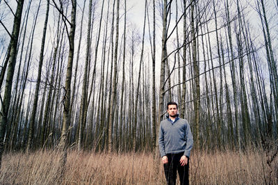 Portrait of man standing in forest