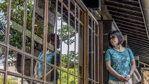 Woman standing by railing