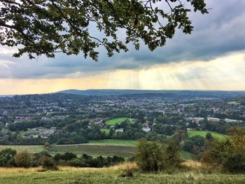 Scenic view of field against cloudy sky