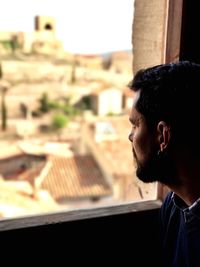 Man looking through window at castillo de mora de rubielos