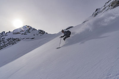 People skiing on snowcapped mountain