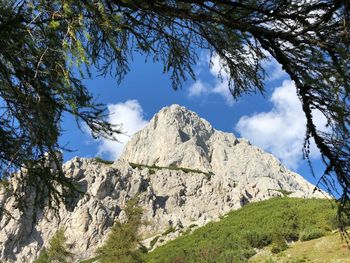 Low angle view of rocky mountain against sky