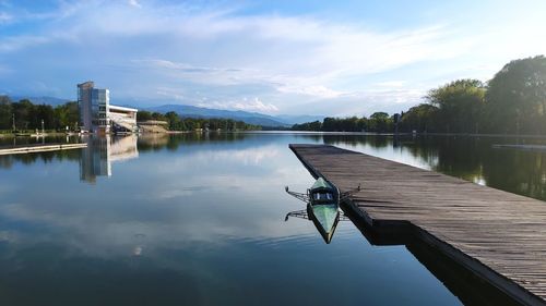 Pier on lake against sky