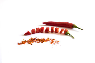 Close-up of red chili pepper against white background