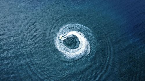 High angle view of jet ski on sea spinning