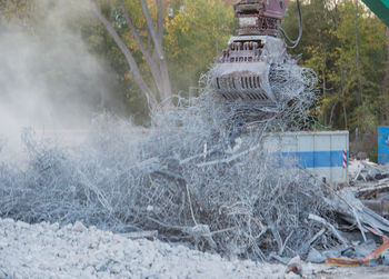 Excavator carrying abandoned metal
