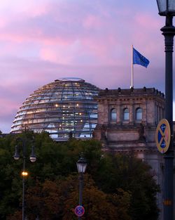 Buildings in city against sky at dusk