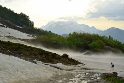 Scenic view of beach against cloudy sky