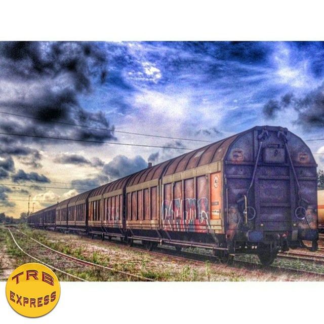 sky, transportation, cloud - sky, cloudy, train - vehicle, text, mode of transport, public transportation, cloud, rail transportation, western script, transfer print, railroad track, communication, auto post production filter, land vehicle, overcast, outdoors, day, no people