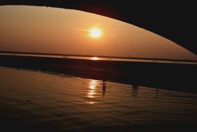 Scenic view of beach against sky during sunset