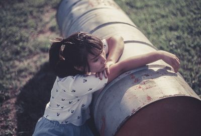 High angle view of young woman leaning on tunnel