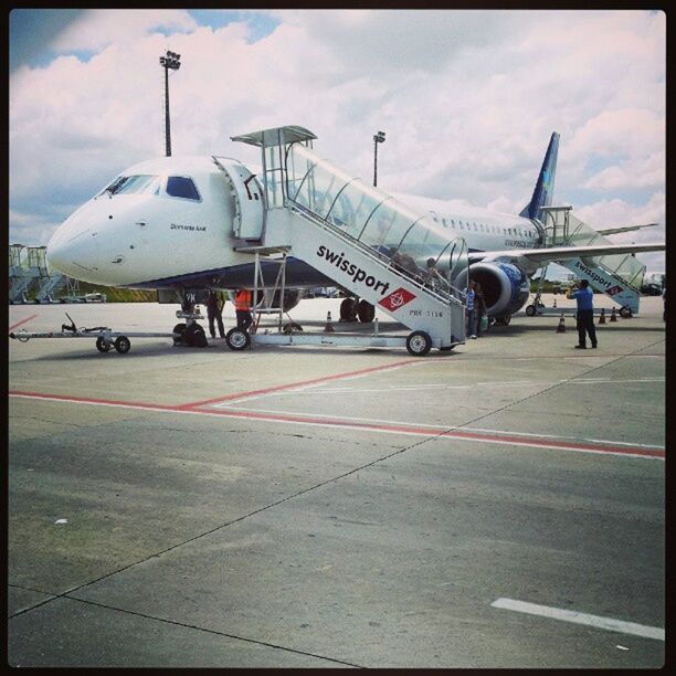 transportation, mode of transport, transfer print, airplane, air vehicle, sky, public transportation, travel, auto post production filter, cloud - sky, airport, journey, on the move, land vehicle, airport runway, day, car, aircraft wing, outdoors, built structure