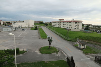 High angle view of road by buildings in city against sky