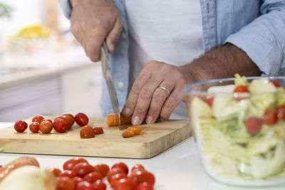 Midsection of man preparing food