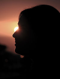 Side view of silhouette man against sky during sunset
