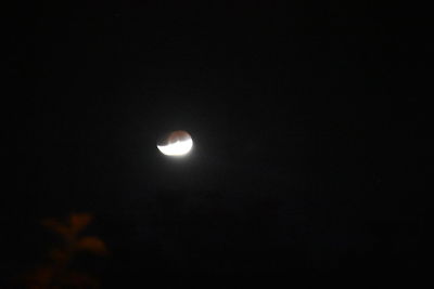 Low angle view of moon against sky at night