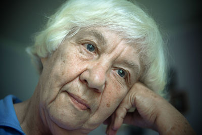 Close-up of thoughtful senior woman with head cocked