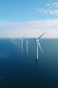 Drone aerial view of windmill turbines generating green energy electric.ai generated